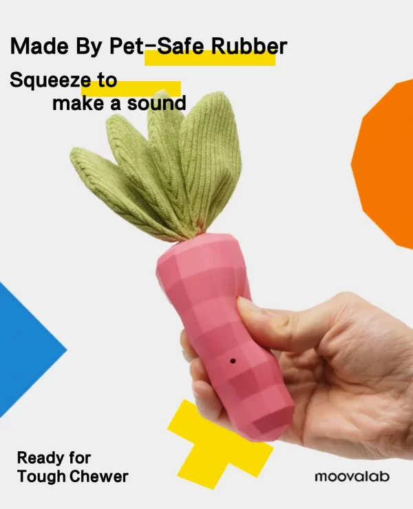 It's a pink, pixelated carrot-shaped toy with green textured leaves. A hand is shown holding the toy, demonstrating its size and how to use it.