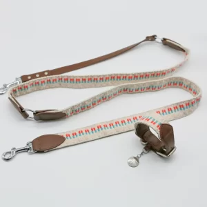 This image displays a durable leash and collar set, crafted with a woven fabric and leather accents. The set offers both functionality and style, making it perfect for daily walks or special occasions.