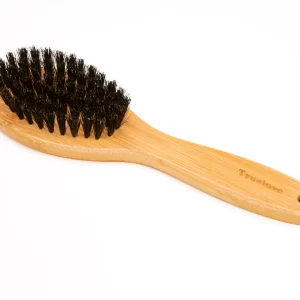 This angled view highlights the quality craftsmanship of the Truelove soft bristle brush for dogs. The sustainable bamboo handle offers a comfortable grip, while the densely packed bristles are designed to remove loose hair and distribute natural oils, promoting a healthy, glossy finish for your pet.