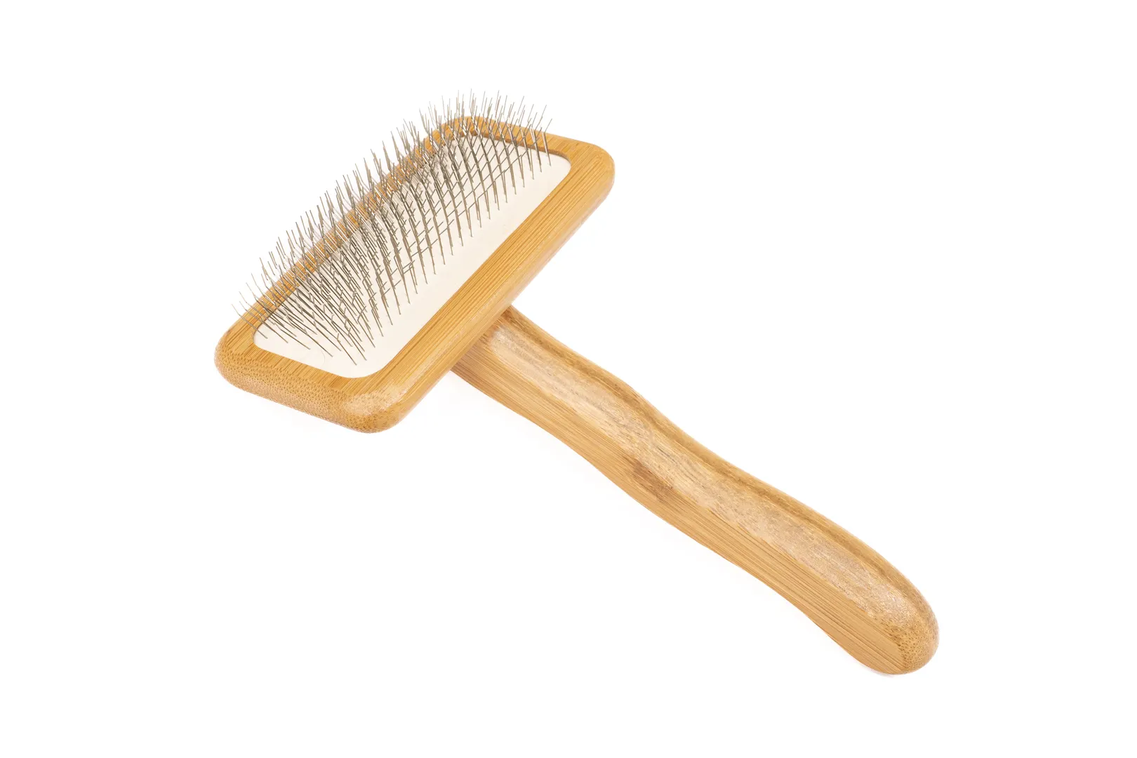 This image showcases a professional-grade slicker brush for dogs. The brush boasts a durable bamboo handle ergonomically designed for comfortable use, while the densely packed, fine-wire pins gently yet effectively remove mats, tangles, and loose fur from your dog's coat. The slicker brush for dogs is a must-have for any dog owner seeking to maintain their pet's coat health and shine. Its sturdy construction ensures long-lasting use.