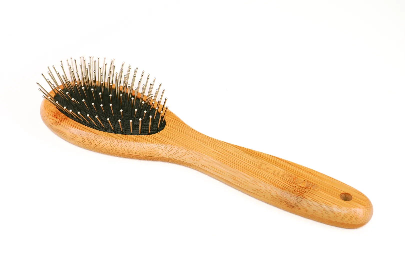 Showcasing its elegant form against a clean white background, this image details the bamboo pin brush for dogs. The light wood handle, black cushioned base, and rounded-tip metal pins are all visible, emphasizing a tool designed for both effectiveness and your pet's ultimate comfort during use.