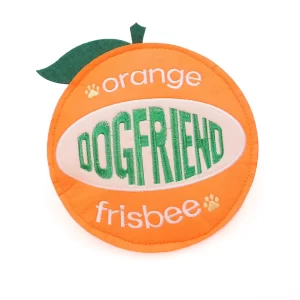 Expanding on its playful design, this orange dog toy is more than just a simple disc. It features detailed embroidery with the words "orange," "DOGFRIEND," and "frisbee," plus charming paw print accents. A small green felt leaf at the top completes its fun, fruity look.