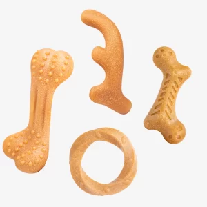 A flat lay of four distinct wooden dog chew toy designs made from a wood composite material. The collection features a large bone with dental nubs, a smooth antler shape, a smaller bone with spine-like textures, and a twisted circular ring for varied chewing experiences.
